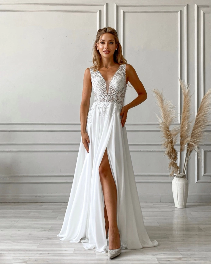 Белое свадебное платье с разрезом по ноге и декольте фото 1